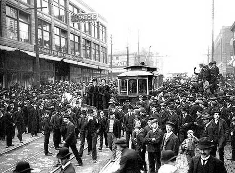 Seattle, March 1903. Crowd surrounding streetcar during strike against Seattle Electric Co., in front of Bon Marche, 2nd Ave. and Pike St.
